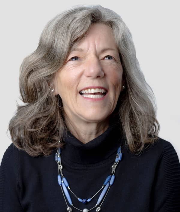 Cathy Nesbitt smiling outdoors, advocate for vermicomposting, sprouts, and laughter yoga.